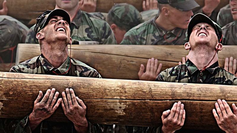 Navy SEALS candidates felling the pain on a log carry.